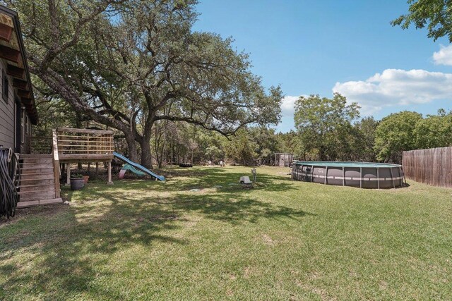 360 Little Barton Dr, Dripping Springs, TX 78620 - view of green lawn featuring a playground and stairs