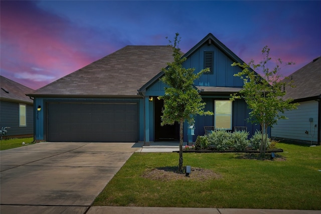 225 Sweetwater Creek Ln, Hutto, TX 78634 - view of front facade with an attached garage, board and batten siding, driveway, and a front lawn