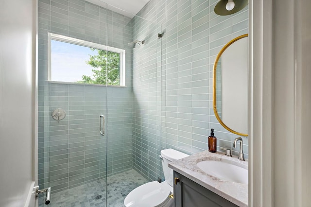 2403 E 22nd St, Austin, TX 78722 - bathroom with tile walls, a shower stall, vanity, and toilet