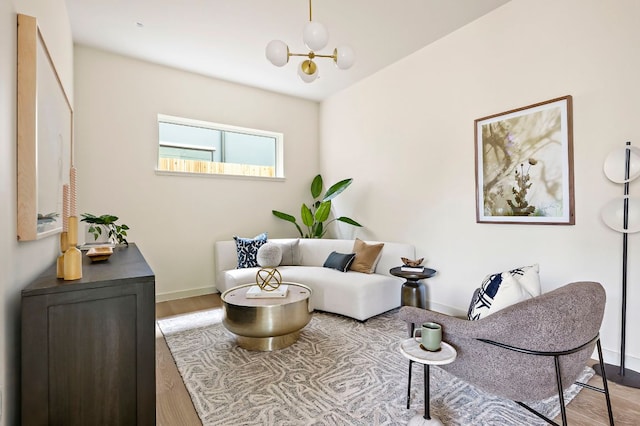 2403 E 22nd St, Austin, TX 78722 - living room featuring wood finished floors and a chandelier