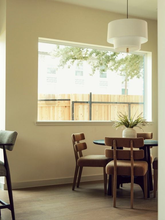 2403 E 22nd St, Austin, TX 78722 - dining space with plenty of natural light, wood finished floors, and baseboards