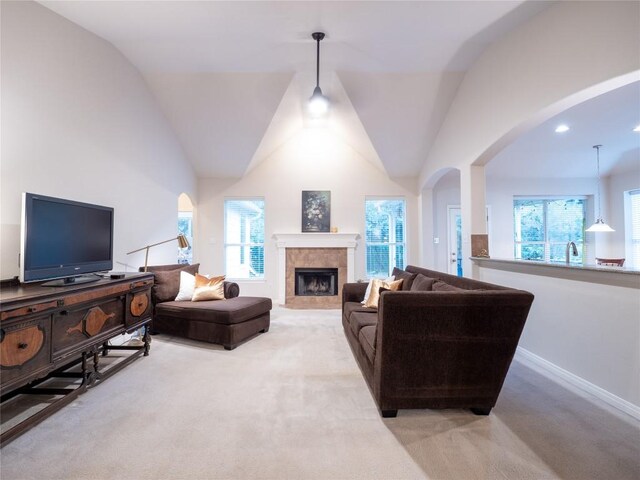 2214 Yellow Bird Trl, Austin, TX 78734 - living area featuring light carpet, a tile fireplace, healthy amount of natural light, and lofted ceiling