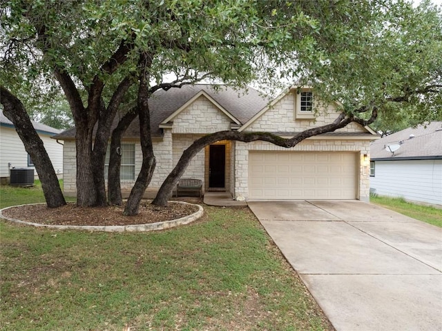 2214 Yellow Bird Trl, Austin, TX 78734 - view of front of home with stone siding, concrete driveway, cooling unit, and a front lawn