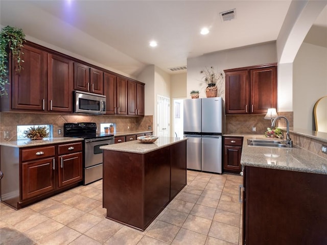 2214 Yellow Bird Trl, Austin, TX 78734 - kitchen with appliances with stainless steel finishes, a sink, decorative backsplash, light tile patterned floors, and recessed lighting