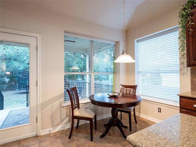 2214 Yellow Bird Trl, Austin, TX 78734 - dining room with baseboards, plenty of natural light, lofted ceiling, and light tile patterned floors