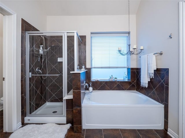 2214 Yellow Bird Trl, Austin, TX 78734 - full bathroom with a chandelier, a bath, a shower stall, and tile patterned floors