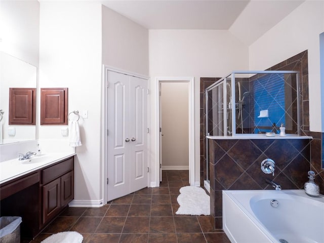 2214 Yellow Bird Trl, Austin, TX 78734 - bathroom with vanity, a stall shower, a garden tub, tile patterned floors, and lofted ceiling