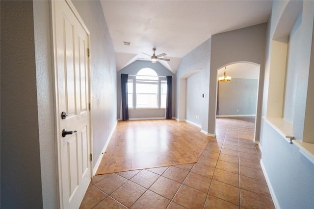 1118 Connemara Ln, Pflugerville, TX 78660 - hall featuring arched walkways, tile patterned floors, and lofted ceiling