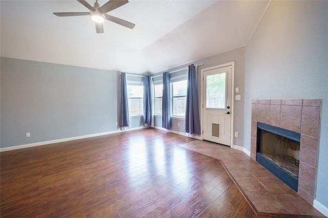 1118 Connemara Ln, Pflugerville, TX 78660 - unfurnished living room featuring wood finished floors, a fireplace, a ceiling fan, and baseboards