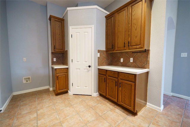 1118 Connemara Ln, Pflugerville, TX 78660 - kitchen with brown cabinets, light countertops, and decorative backsplash