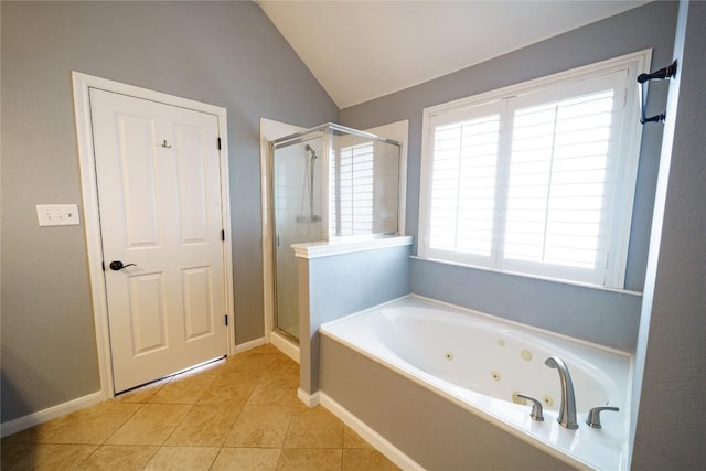 1118 Connemara Ln, Pflugerville, TX 78660 - full bath with a stall shower, a tub with jets, tile patterned flooring, lofted ceiling, and baseboards