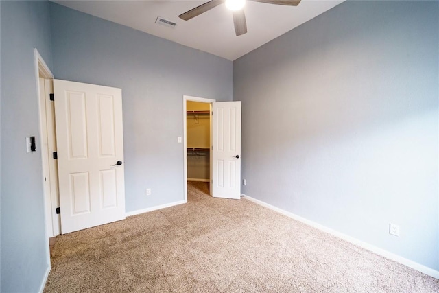 1118 Connemara Ln, Pflugerville, TX 78660 - unfurnished bedroom with carpet, a walk in closet, a closet, and a ceiling fan