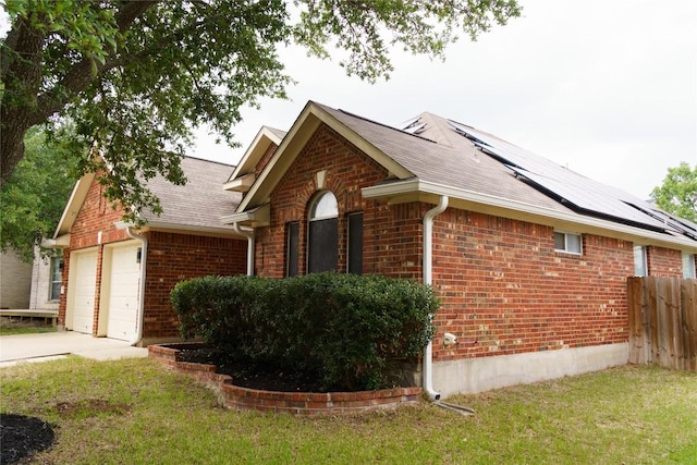 1118 Connemara Ln, Pflugerville, TX 78660 - view of property exterior with brick siding, driveway, solar panels, roof with shingles, and a garage