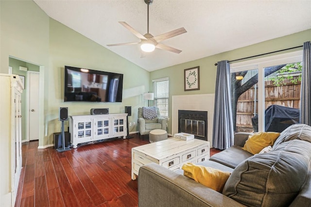 12320 Cedarspur Rd, Austin, TX 78758 - living room featuring a ceiling fan, dark wood finished floors, a tile fireplace, high vaulted ceiling, and baseboards