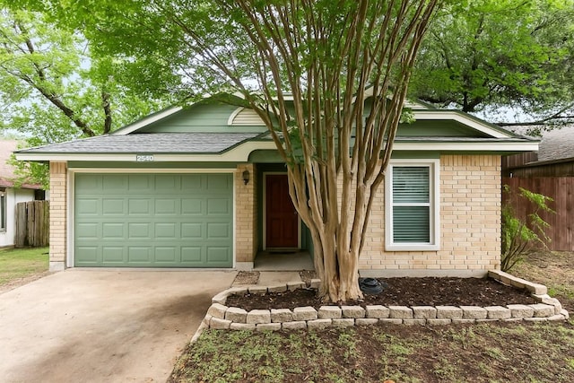12320 Cedarspur Rd, Austin, TX 78758 - view of front of home featuring brick siding, driveway, and a garage