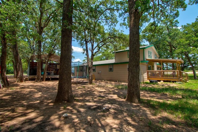 1162 N State Highway 95, Bastrop, TX 78602 - view of yard with a trampoline and a deck