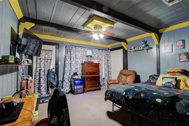 1162 N State Highway 95, Bastrop, TX 78602 - carpeted bedroom with beamed ceiling, wood walls, and a ceiling fan