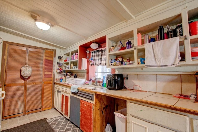 1162 N State Highway 95, Bastrop, TX 78602 - kitchen with tile countertops, open shelves, a sink, and light tile patterned flooring