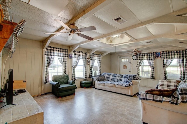 1162 N State Highway 95, Bastrop, TX 78602 - living area featuring ceiling fan, healthy amount of natural light, and wood walls