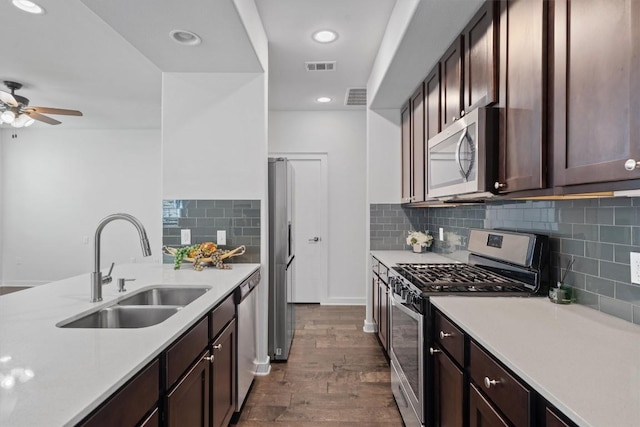 8940 Parker Ranch Cir Unit B, Austin, TX 78748 - kitchen with stainless steel appliances, light countertops, dark wood-style flooring, a sink, and recessed lighting