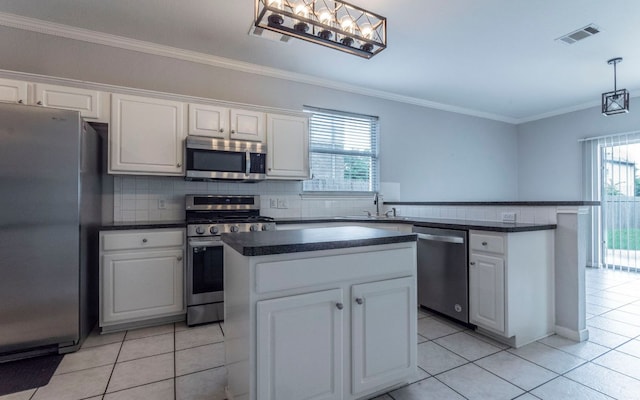 208 Settlers Valley Dr, Pflugerville, TX 78660 - kitchen featuring appliances with stainless steel finishes, light tile patterned flooring, dark countertops, white cabinetry, and ornamental molding