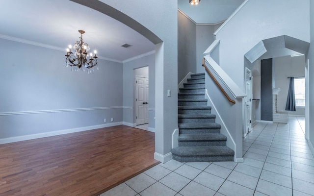 208 Settlers Valley Dr, Pflugerville, TX 78660 - staircase featuring arched walkways, a chandelier, crown molding, wood finished floors, and baseboards