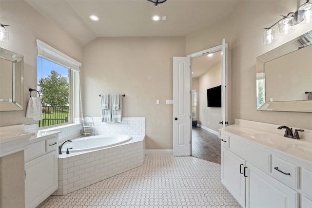 403 Baldovino Skwy, Austin, TX 78738 - bathroom with a garden tub, two vanities, and recessed lighting