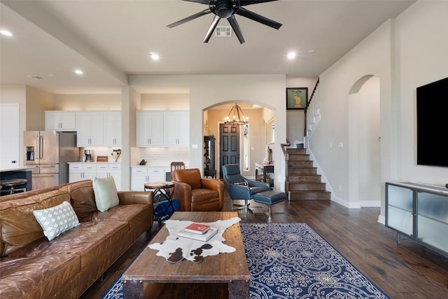 403 Baldovino Skwy, Austin, TX 78738 - living area with arched walkways, dark wood-style flooring, ceiling fan, recessed lighting, and stairs