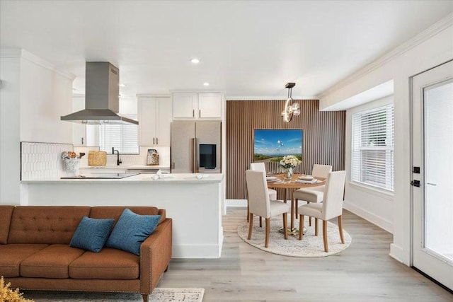 6102 Amber Pass, Austin, TX 78745 - kitchen with built in fridge, island range hood, open floor plan, light countertops, and a chandelier