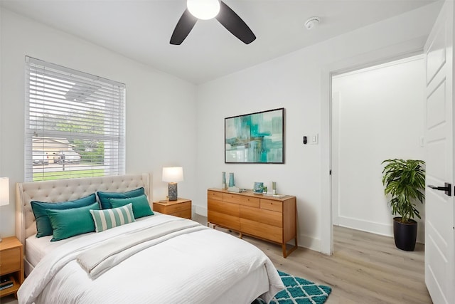 6102 Amber Pass, Austin, TX 78745 - bedroom with light wood-type flooring, baseboards, and ceiling fan