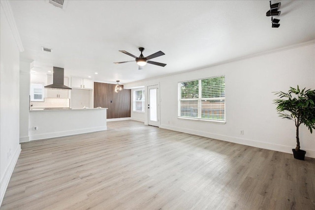 6102 Amber Pass, Austin, TX 78745 - unfurnished living room with baseboards, light wood-style floors, ceiling fan, crown molding, and recessed lighting