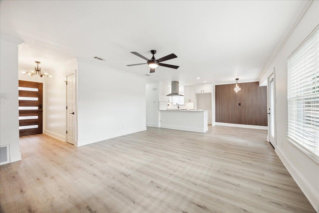 6102 Amber Pass, Austin, TX 78745 - unfurnished living room with a chandelier, ornamental molding, light wood-type flooring, and a ceiling fan