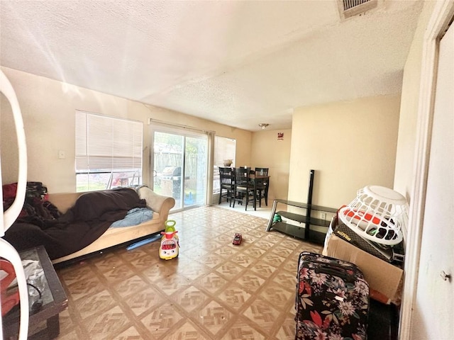 5005 S Pleasant Valley Rd, Austin, TX 78744 - living room featuring light flooring and a textured ceiling