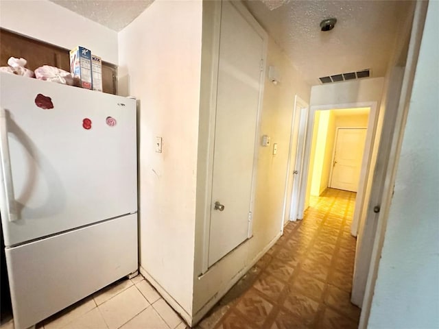 5005 S Pleasant Valley Rd, Austin, TX 78744 - kitchen with freestanding refrigerator and a textured ceiling