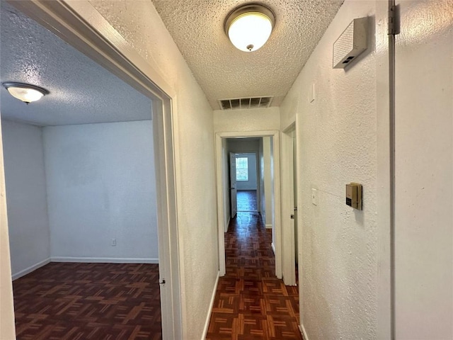 5005 S Pleasant Valley Rd, Austin, TX 78744 - corridor featuring a textured ceiling, a textured wall, and baseboards