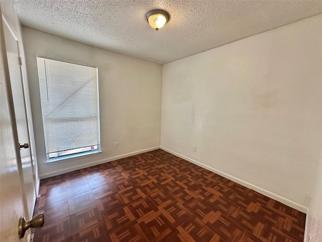 5005 S Pleasant Valley Rd, Austin, TX 78744 - empty room featuring a textured ceiling and baseboards