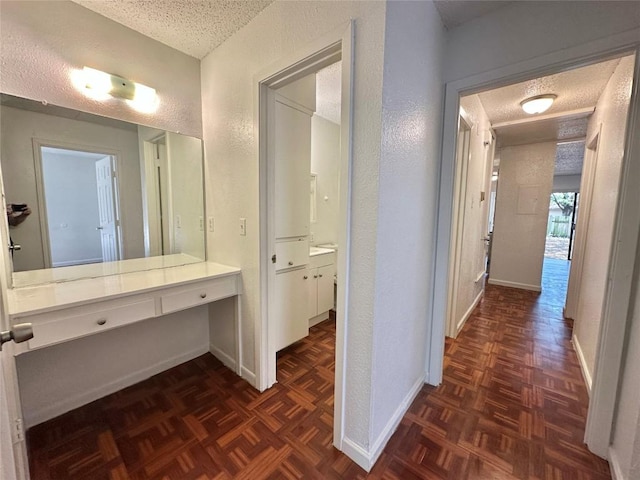 5005 S Pleasant Valley Rd, Austin, TX 78744 - hallway with a textured ceiling, a textured wall, baseboards, and an office area