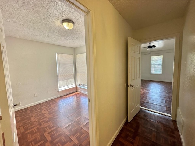 5005 S Pleasant Valley Rd, Austin, TX 78744 - hall with baseboards and a textured ceiling