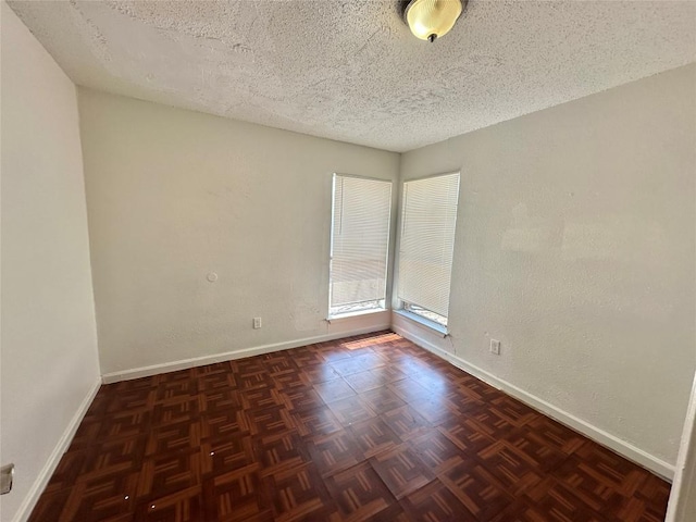 5005 S Pleasant Valley Rd, Austin, TX 78744 - spare room featuring baseboards and a textured ceiling