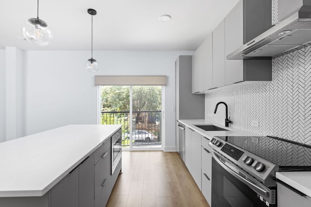 2500 Longview St Unit 101, Austin, TX 78705 - kitchen with appliances with stainless steel finishes, wall chimney range hood, modern cabinets, gray cabinetry, and light countertops
