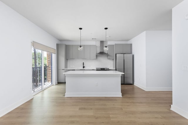 2500 Longview St Unit 101, Austin, TX 78705 - kitchen with wall chimney range hood, appliances with stainless steel finishes, gray cabinetry, light countertops, and backsplash