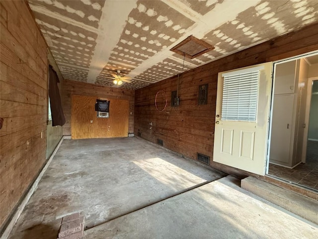 429 Camelback Rd, La Grange, TX 78945 - unfurnished room with wooden walls and unfinished concrete floors