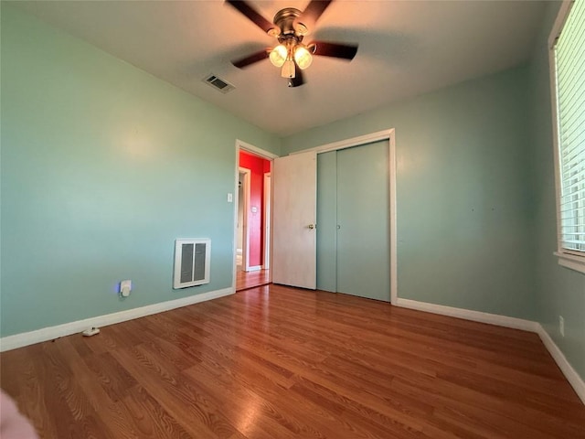 429 Camelback Rd, La Grange, TX 78945 - unfurnished bedroom with wood finished floors, baseboards, a closet, and ceiling fan