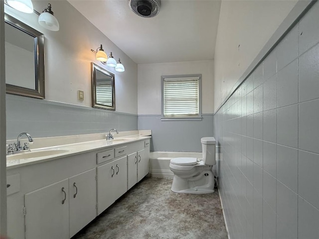 429 Camelback Rd, La Grange, TX 78945 - full bath featuring tile walls, toilet, double vanity, a tub, and wainscoting