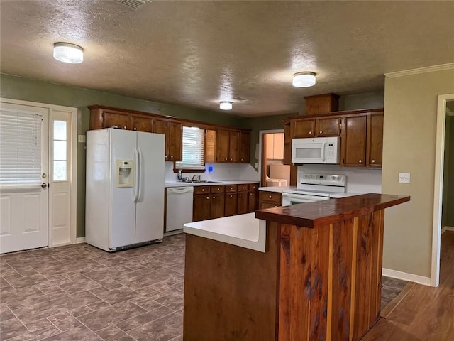 429 Camelback Rd, La Grange, TX 78945 - kitchen featuring white appliances, a textured ceiling, a sink, and baseboards