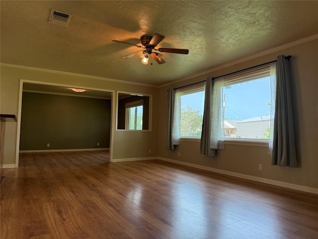 429 Camelback Rd, La Grange, TX 78945 - empty room featuring ceiling fan, a textured ceiling, wood finished floors, crown molding, and baseboards