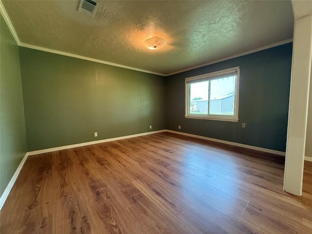 429 Camelback Rd, La Grange, TX 78945 - spare room featuring wood finished floors, a textured ceiling, crown molding, and baseboards