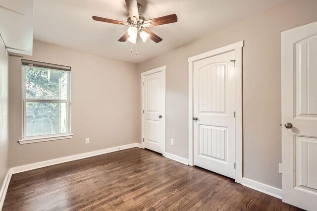 704 Wren Ave, Austin, TX 78753 - unfurnished bedroom featuring dark wood-style floors, baseboards, and ceiling fan