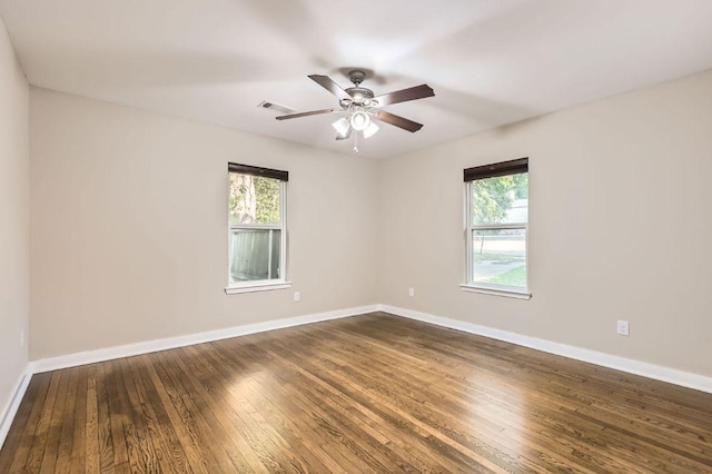 704 Wren Ave, Austin, TX 78753 - unfurnished room featuring healthy amount of natural light, dark wood-type flooring, baseboards, and ceiling fan