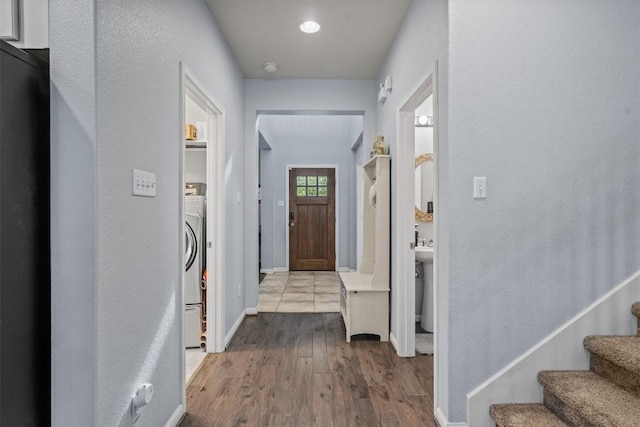 13625 Glen Creek Ct, Manor, TX 78653 - entryway featuring wood finished floors, stairway, baseboards, and washer / dryer